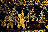 Wat Xieng Thong temple in Luang Prabang, Laos. Detail of the  intricate gold stencilling on black lacquer that decorate the walls of the sim. 